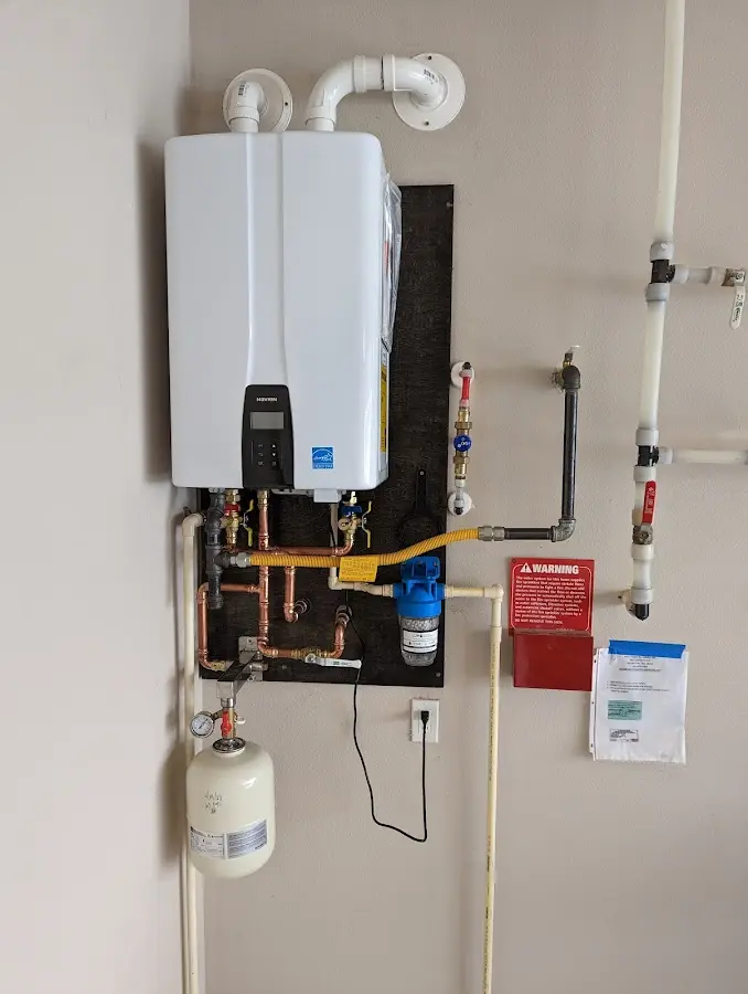 Professional plumber installing copper piping in a Summit home